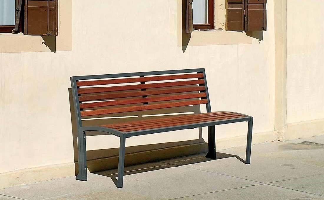 Banco Camilla con respaldo en metal y madera y reposabrazos.